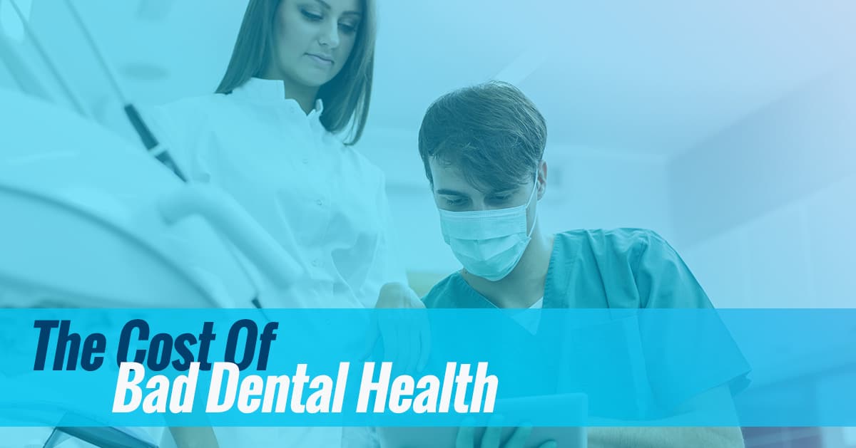 Two dental professionals wearing masks examine patient in clinical dental office setting.