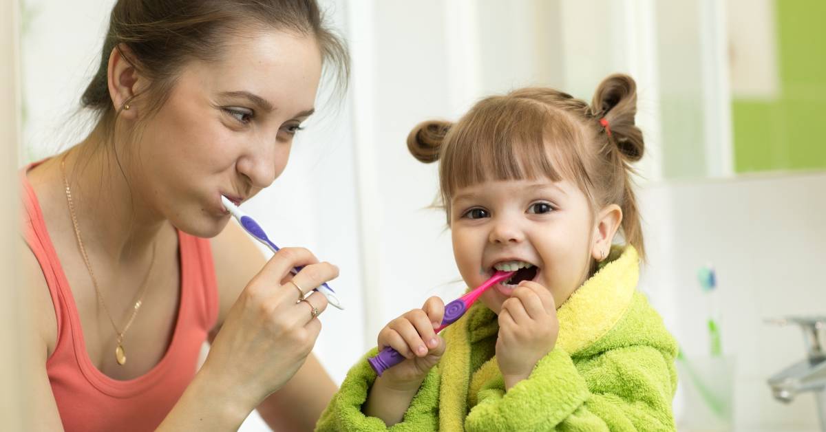 image of a mom and child brushing teeth