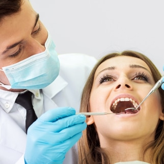 Image of a woman getting a teeth cleaning