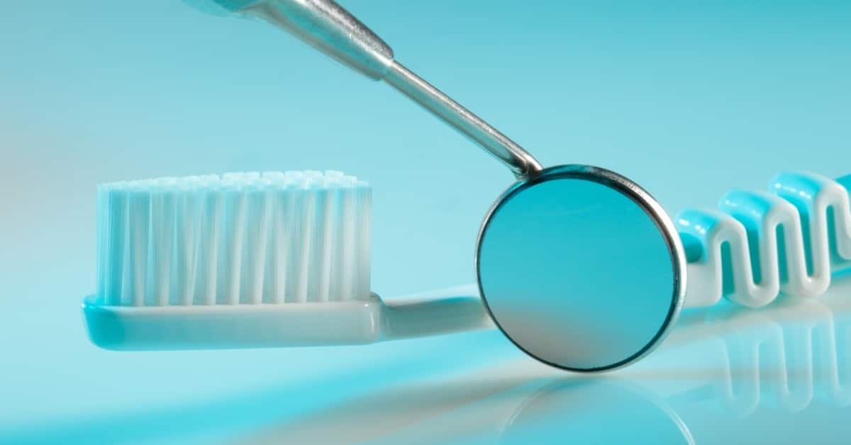 image of a dental mirror and tooth brush