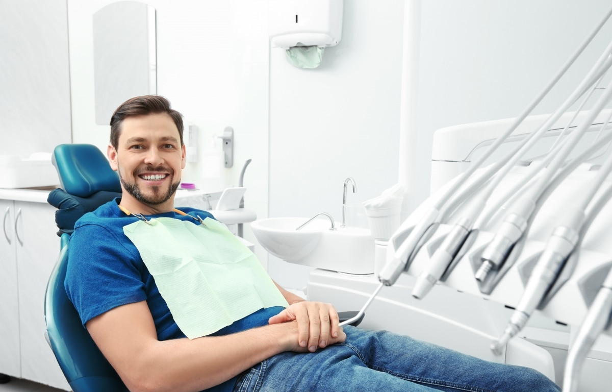 Image of a man in a dental chair smiling