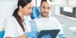 Image of a dental assistant talking to a patient