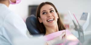 image of a woman smiling in a dentist chair