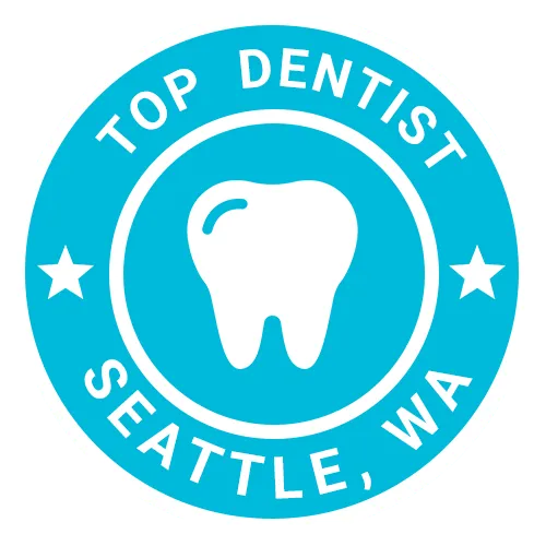 Top Dentist badge for Seattle, WA featuring white tooth icon on blue circular seal
