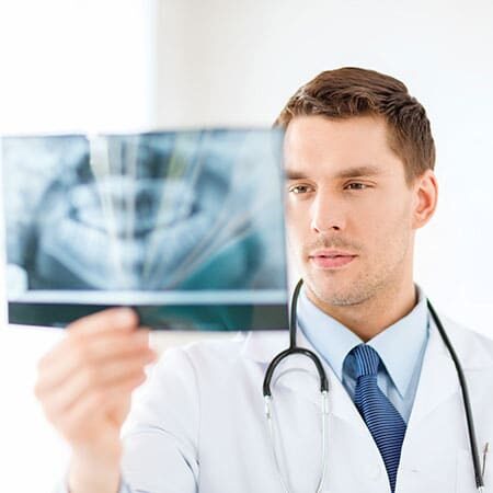 Image of a dentist looking at an xray