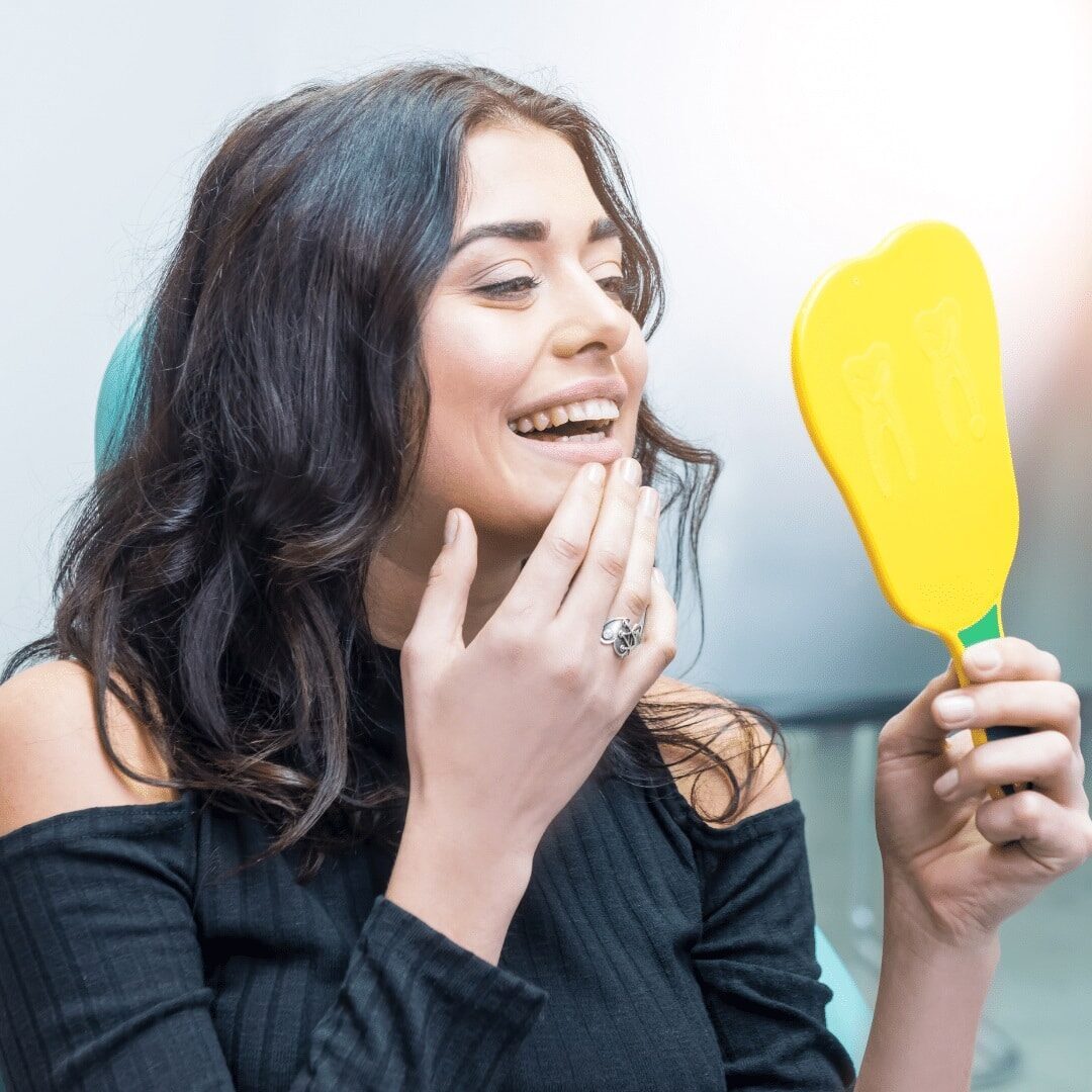 dentist in Seattle helping patient smile confidently