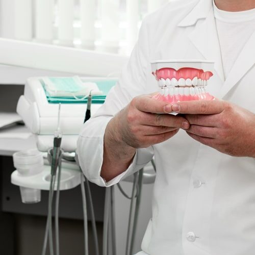 Image of a dentist holding teeth