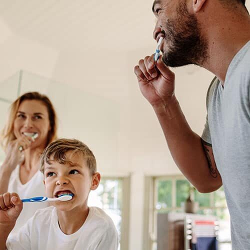 Image of a family brushing teeth